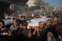 An Israeli security official says the transfer of aid into Gaza is halted after a Hamas ceasefire violation
